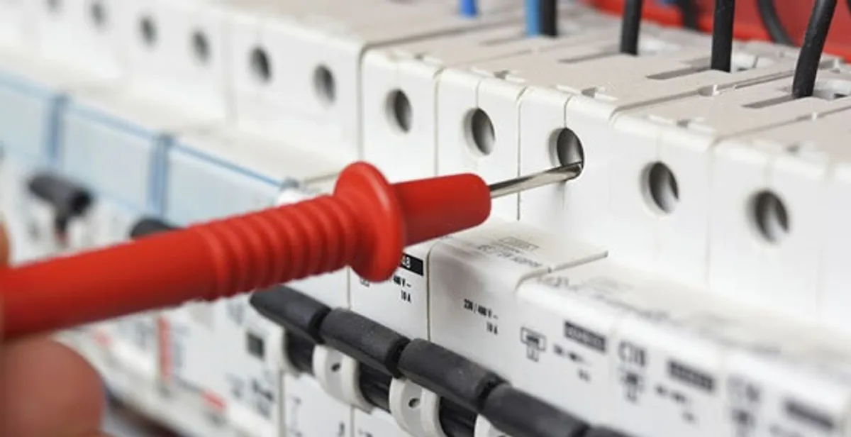 Electrical contractor testing circuit breakers during electrical repair in Fowler, CA