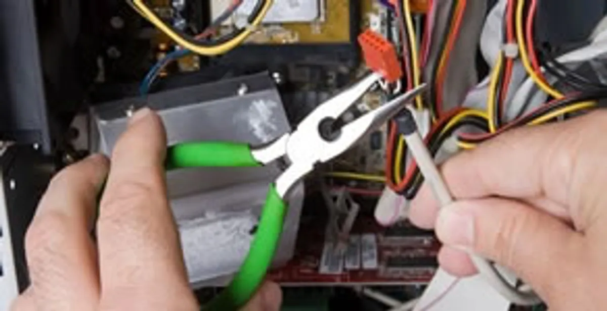 Licensed electrical contractor performing electrical repair with tools in Madera, CA