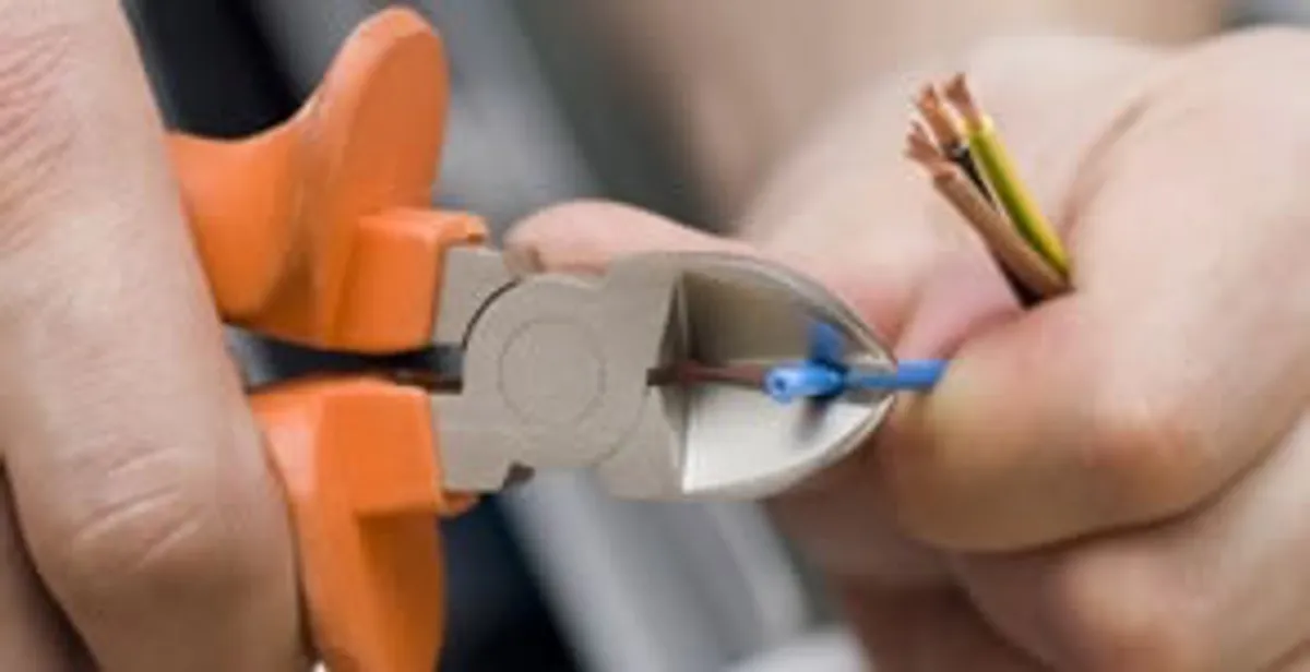 professional electrical services showing precise wire cutting by licensed electricians in Fresno, CA